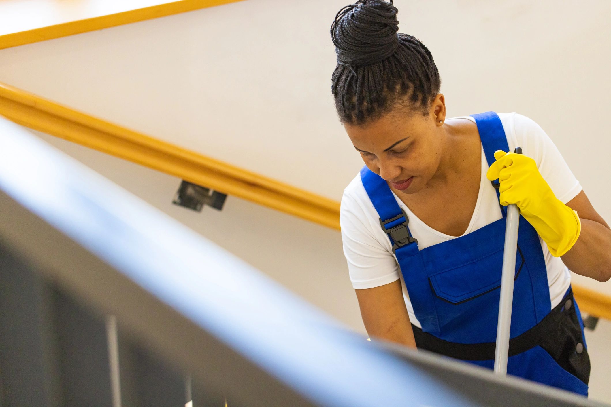 Professional commercial cleaner mopping stairs